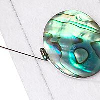 Needle beading around a cabochon